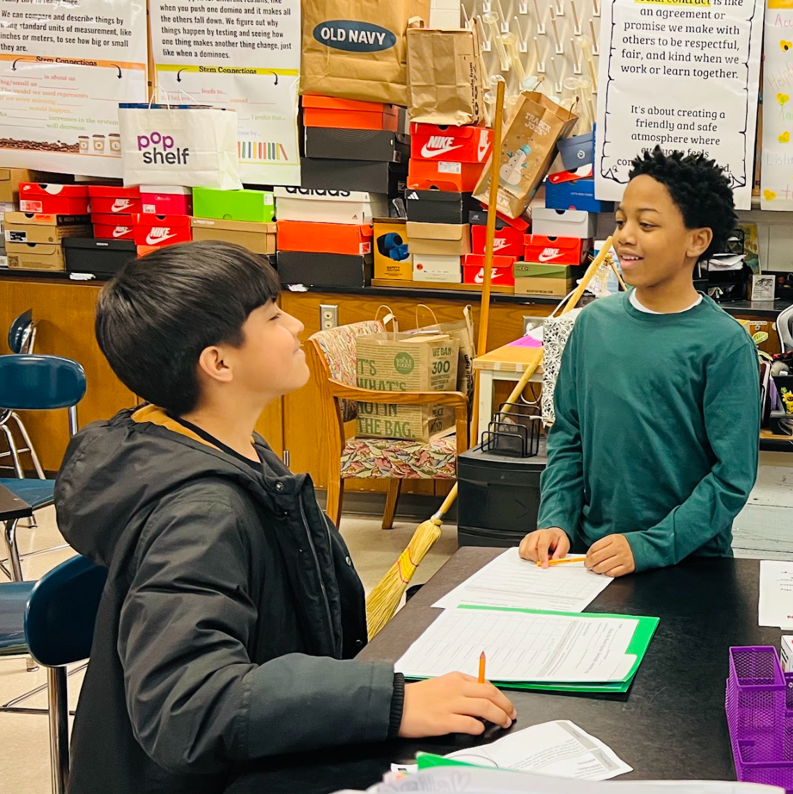  6th graders work at a science station